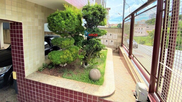 A small garden area with a potted plant and a decorative stone.