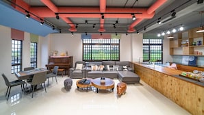 A modern living room with a sofa, coffee table, and dining area. - Young Villa (Wujie)