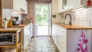 A kitchen with white cabinets, a wooden countertop, a toaster, and a sink. - 4 Person Holiday Home in Oksbol-by Traum (Oksbol)