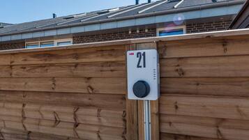 A wooden fence with a metal device labeled '21' attached to it.