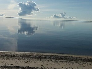 A calm body of water with a clear sky and a distant shoreline. - 6 Person Holiday Home in Veslos (Vesløs)
