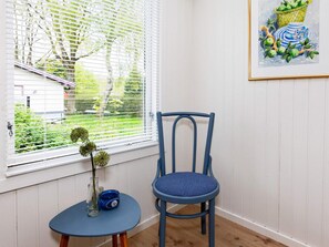 A room with a window, a chair, a small table, and a framed picture on the wall. - 6 Person Holiday Home in Veslos (Vesløs)