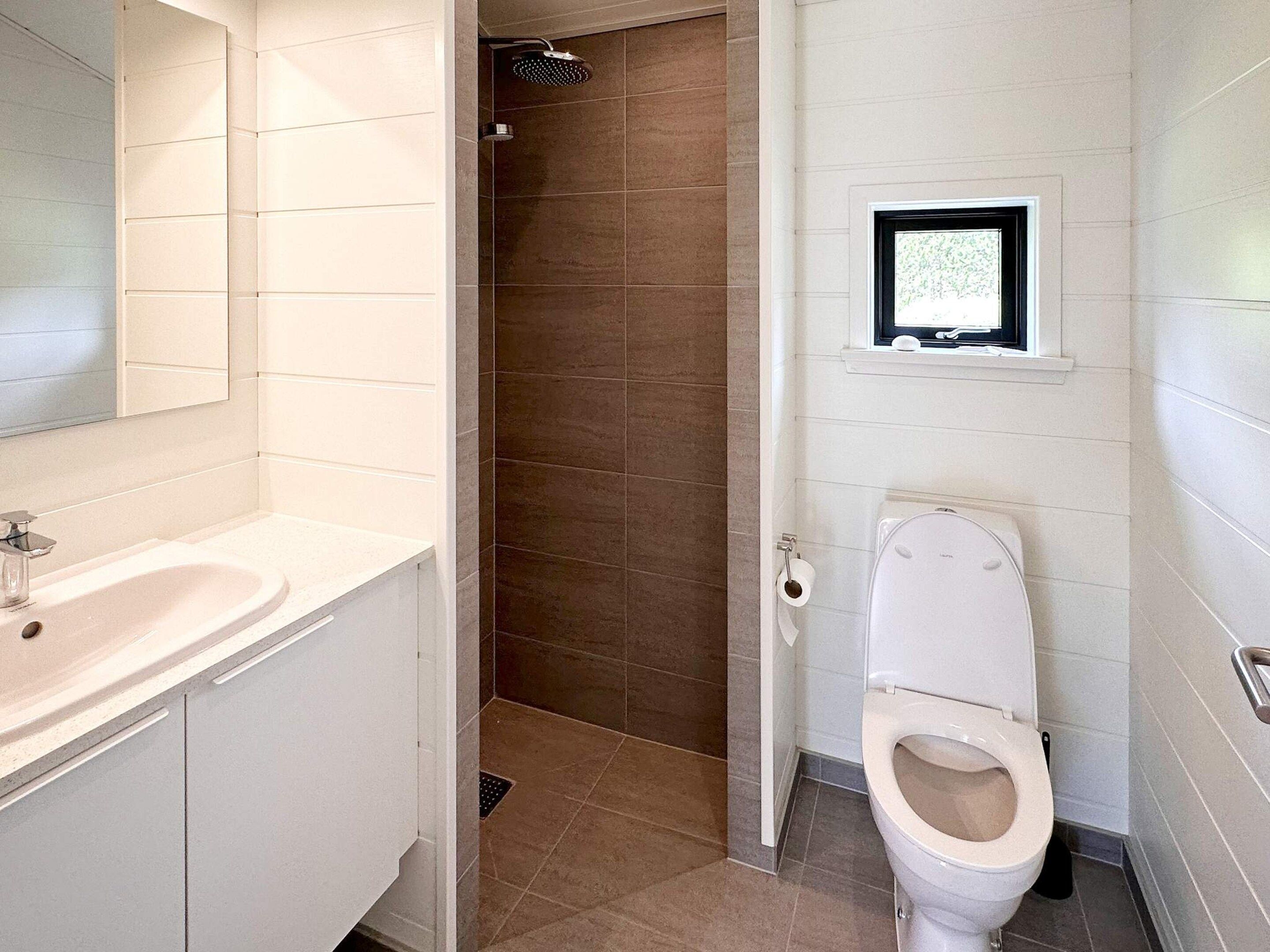 A bathroom with a sink, toilet, and shower.