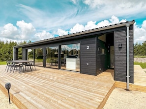 A modern building with a deck, glass doors, and a number '2' on the side. - 7 Person Holiday Home in Jerup-by Traum (Jerup)