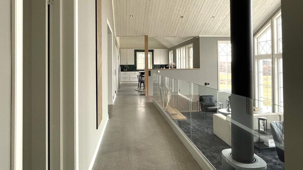 A modern interior with a long corridor, a staircase, and a seating area with a view of the outdoors. - 5 Star Holiday Home in Uddevalla (Uddevalla)