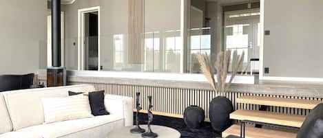 A modern living room with a sofa, coffee table, and a fireplace.