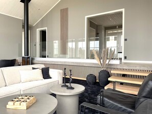A modern living room with a sofa, coffee table, and a fireplace.