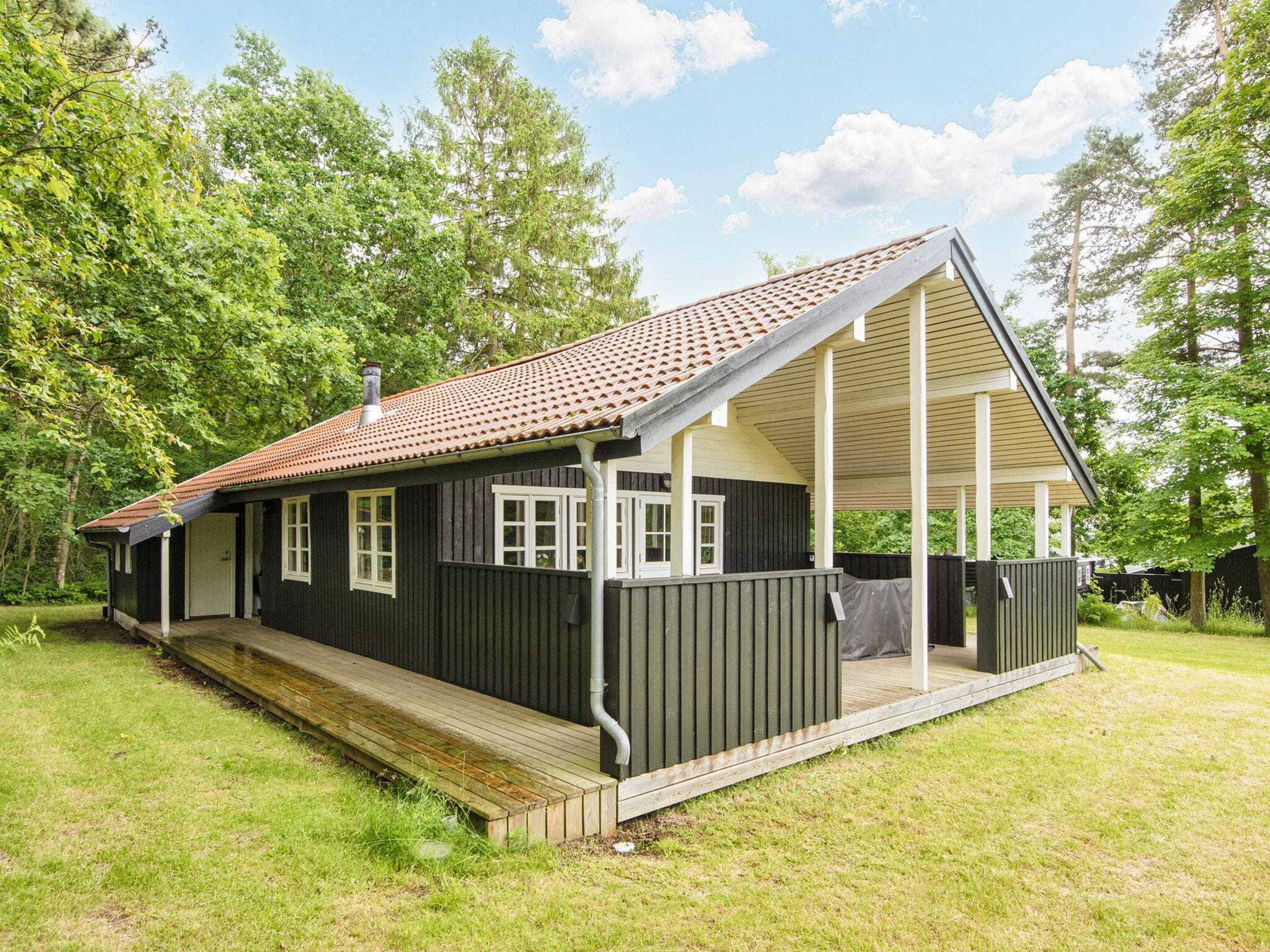 A single-story house with a covered porch and a fenced yard.