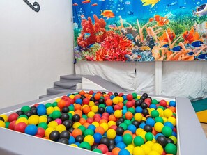 A colorful ball pit with a mural of an underwater scene in the background. - 8 Person Holiday Home in Henne (Henne)
