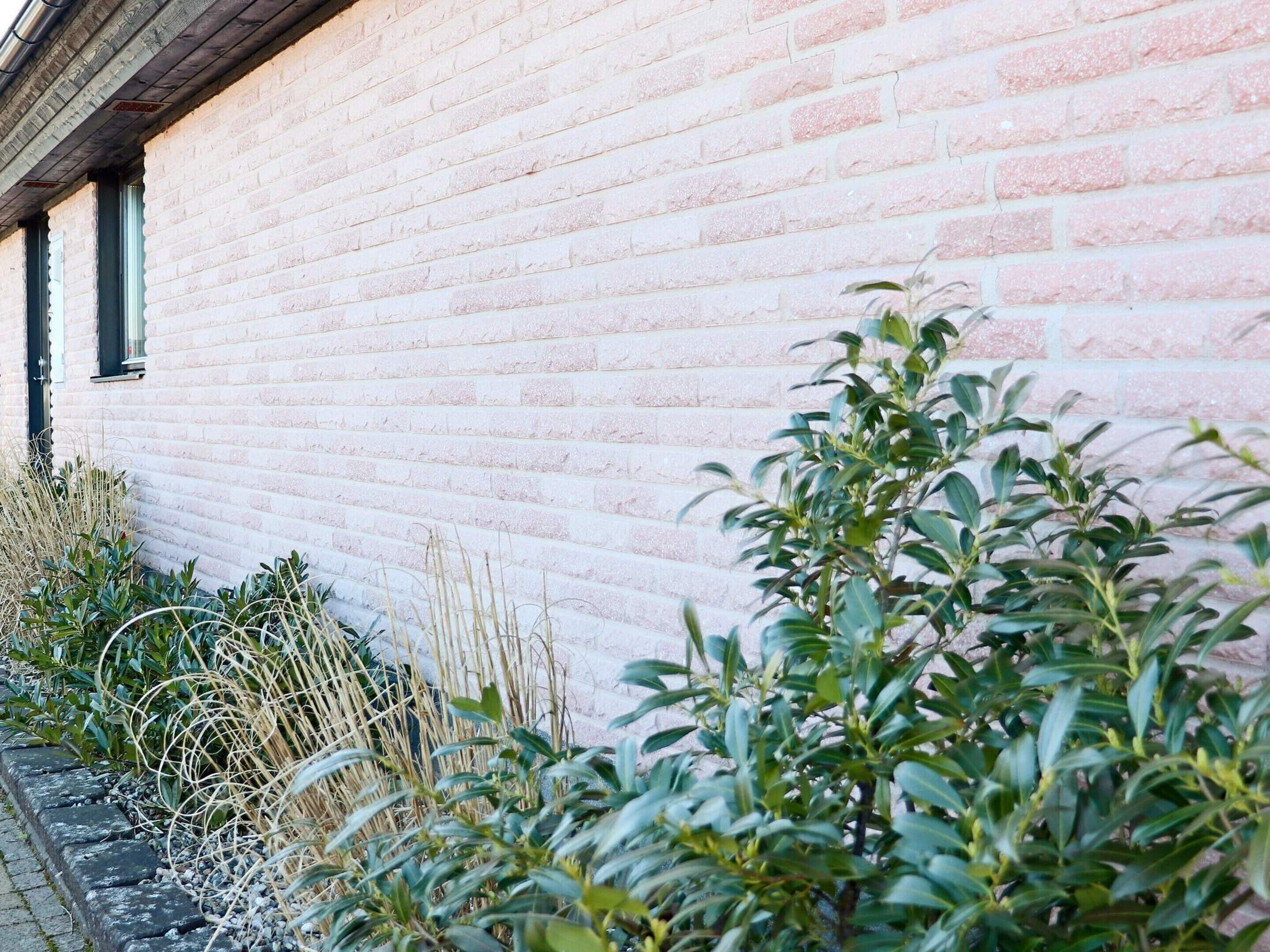 A brick building with a window and a door.