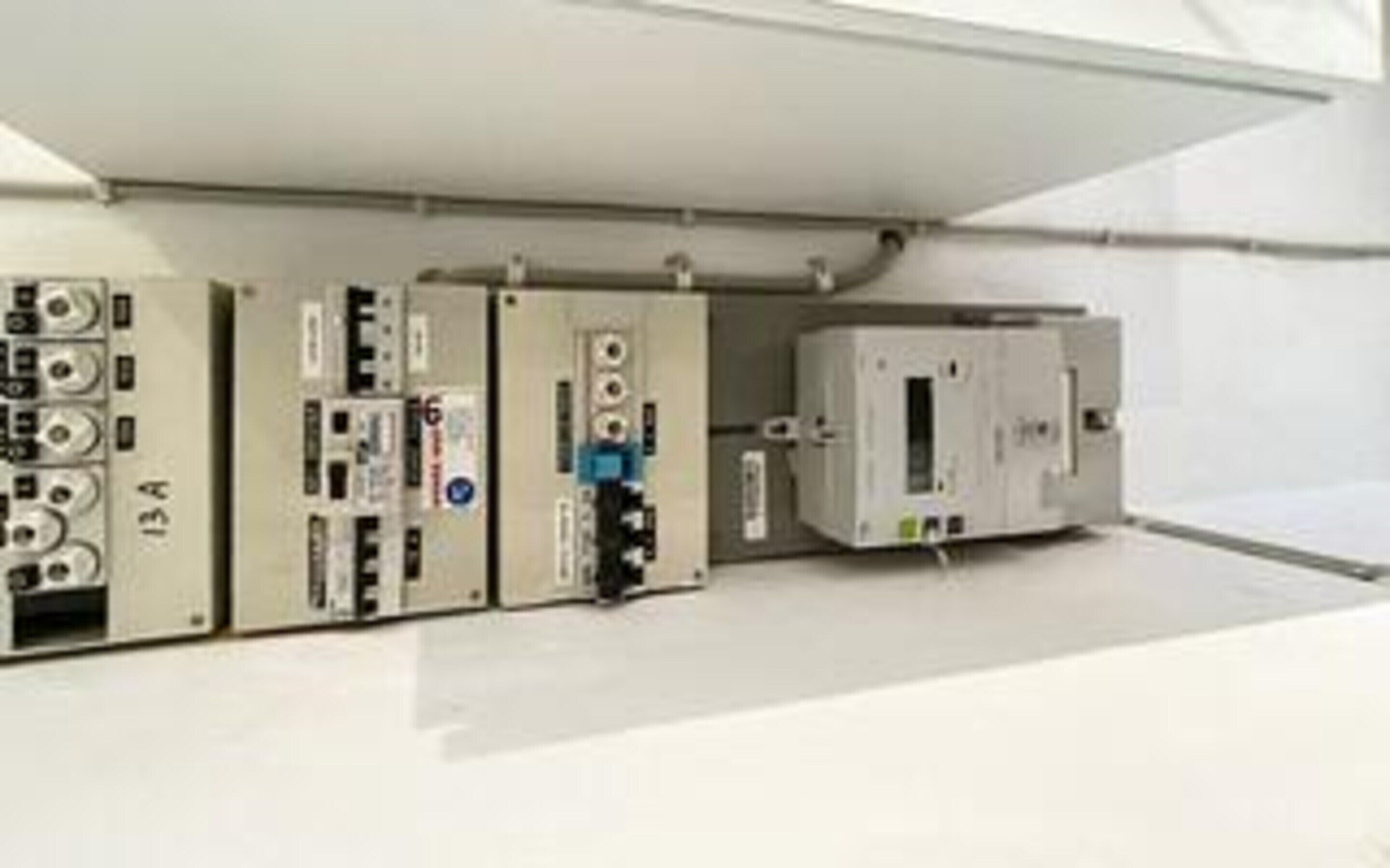 A control panel with various meters and switches, likely for monitoring electrical systems.