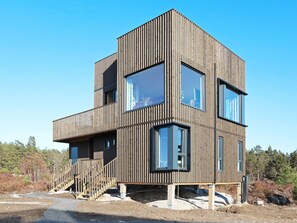 A modern, multi-level wooden cabin with large windows and a staircase. - 4 Star Holiday Home in Sondeled (Risør)