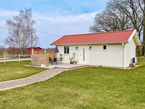 A single-story house with a red-tiled roof, a front porch, and a small patio area. - 4 Star Holiday Home in Bergkvara (Bergkvara)