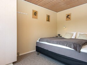 A bedroom with a bed, a bedside table, and two wall-mounted pictures. - 6 Person Holiday Home in Hemmet (Hemmet)
