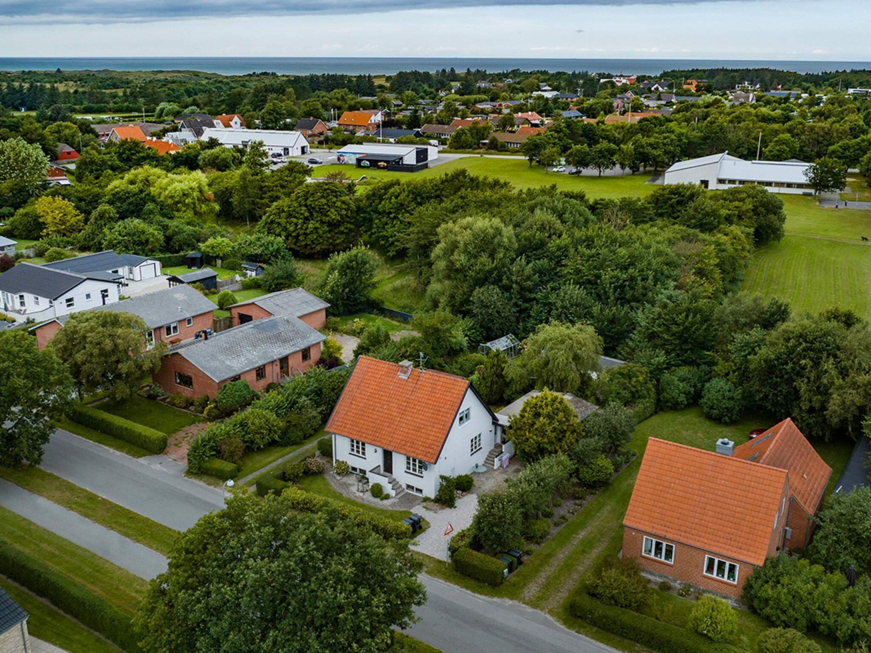 A residential area with houses, roads, and greenery.