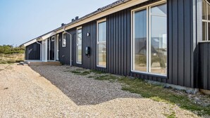 A modern building with large windows and a chimney. - 8 Person Holiday Home in Harboore (Harboore)