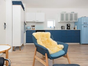 A modern kitchen with blue cabinets, a white countertop, and a blue refrigerator. - 4 Person Holiday Home in Hejls (Hejls)