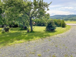 A gravel path leading through a grassy area with trees and shrubs. - 4 Star Holiday Home in Vastra Amtervik (Vastra Amtervik)