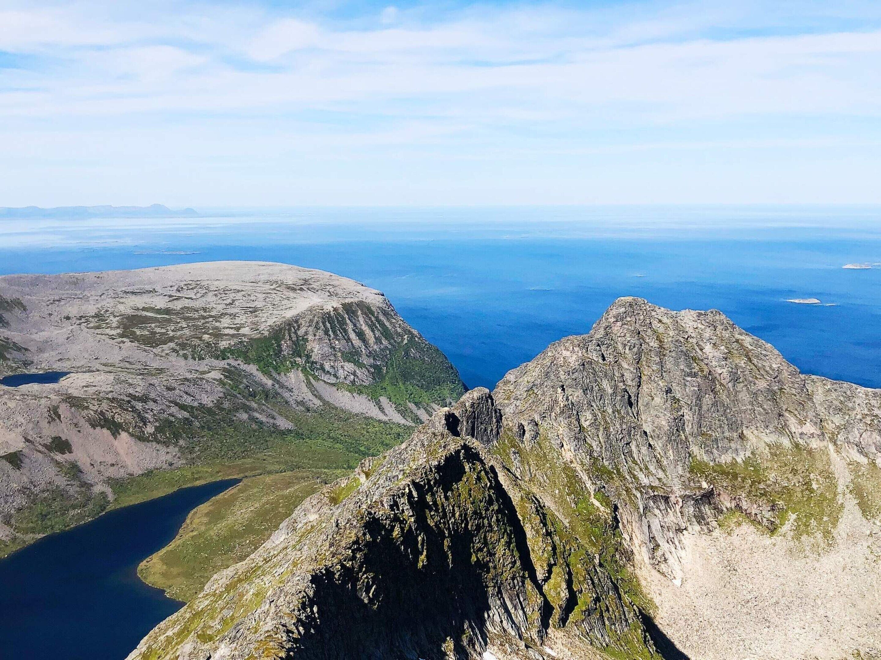 A mountainous landscape with rocky terrain and a lake.
