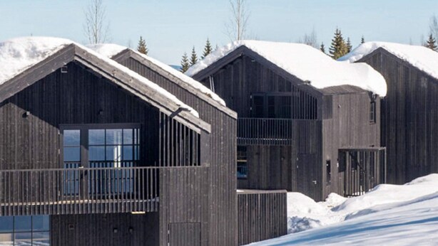 A row of wooden cabins with snow-covered roofs and a clear sky. - 4 Star Holiday Home in Salen (Salen)