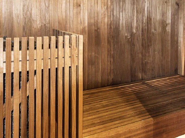 A wooden bench with slatted backrest and seat, adjacent to a wooden wall. - 4 Star Holiday Home in Salen (Salen)