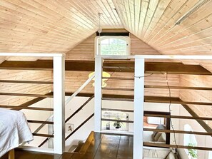 An attic room with wooden beams, a skylight, and a staircase. - 3 Person Holiday Home in Berga (Berga)