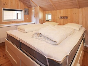 A wooden-paneled bedroom with two beds, a window, and a small skylight. - 8 Person Holiday Home in Hadsund (Hadsund)