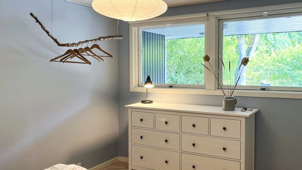 A bedroom with a bed, dresser, window, and decorative items. - 6 Person Holiday Home in Albaek (Aalbaek)