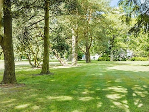 A park with multiple trees and a well-maintained lawn. - 14 Person Holiday Home in Ronne (Akirkeby)