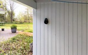 A white exterior wall with a black mailbox.