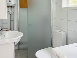 A bathroom with a white sink, toilet, and a shower enclosure. - 4 Star Holiday Home in Varmdo (Fågelbrolandet)