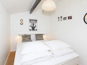 A bedroom with a bed, white walls, a ceiling light, and a framed picture on the wall. - 6 Person Holiday Home in Fjerritslev (Fjerritslev)