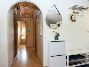 A hallway with wooden walls and a white door at the end.