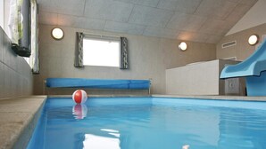 A swimming pool with a blue interior, a window, and a towel rack. - 5 Star Holiday Home in Sydals (Sydals)