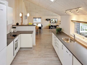 A modern kitchen with a central island, built-in appliances, and pendant lighting. - 14 Person Holiday Home in Sydals (Sydals)