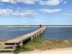 A wooden pier extending into a body of water with a clear sky above. - 6 Person Holiday Home in Hadsund (Hadsund)