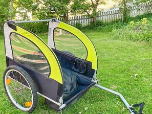 A baby stroller with a canopy, designed for outdoor use, featuring a front wheel and a handle for pushing. - 4 Star Holiday Home in Branno (Branno)