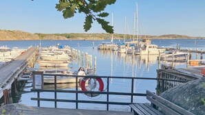 A wooden dock leading to a marina with boats docked. - 4 Star Holiday Home in Branno (Branno)