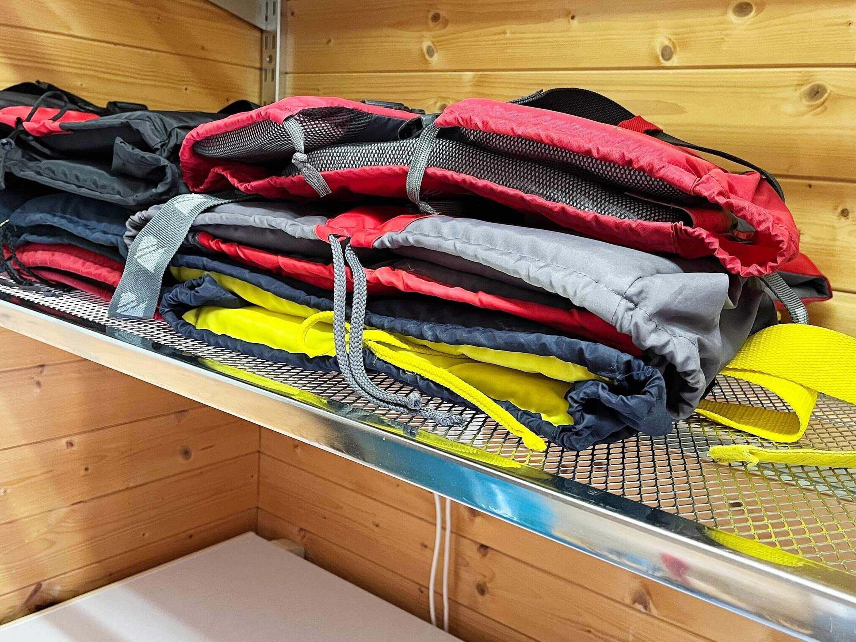 A metal rack with folded clothes in various colors.