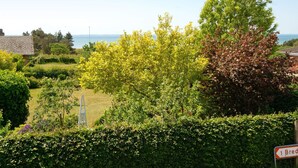A residential area with a view of the sea, a sign indicating '1 Bred', and a ladder leaning against a hedge. - 6 Person Holiday Home in Sydals (Sydals)