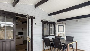 A room with a wooden floor, a table with chairs, a door, and a sign that reads "Godt-Nok". - 4 Person Holiday Home in Karrebaeksminde-by Traum (Karrebæksminde)