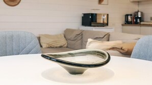 A modern living room with a glass table, a sofa, and a television in the background. - 4 Person Holiday Home in Karrebaeksminde-by Traum (Karrebæksminde)