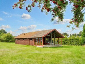 A single-story wooden building with a sloped roof and a covered porch. - 5 Person Holiday Home in Jaegerspris (Jægerspris)