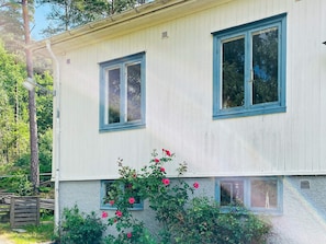 A two-story building with a light-colored exterior and blue trim around the windows.