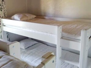 A bunk bed with two levels, each with a pillow and a mattress. - 4 Star Holiday Home in Mellerud (Mellerud)
