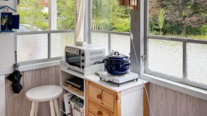 A compact kitchen with a built-in microwave, a slow cooker, and a small stool. - 4 Person Holiday Home in Kolmarden (Kolmården)