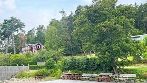 A wooden dock extending into a body of water with picnic tables and benches. - 4 Person Holiday Home in Kolmarden (Kolmården)