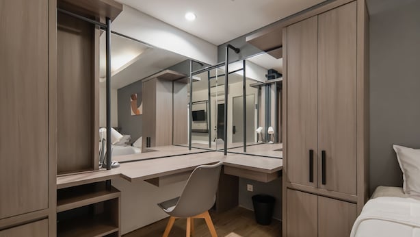 A modern bedroom with a desk, a chair, and a bed. - Cove Art Living (Jakarta)