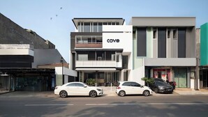 A modern building with the sign 'cove' on the facade, featuring a two-story structure with large windows and a flat roof. - Cove Art Living (Jakarta)