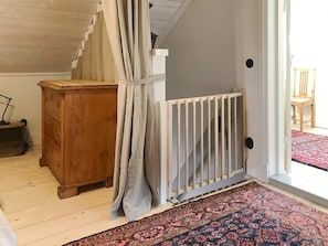 A room with a wooden dresser, a white radiator, and a patterned rug. - 4 Star Holiday Home in Mellosa (Flen)